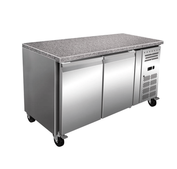 Commercial refrigerated prep counter with stainless steel design and granite top for efficient food preparation.