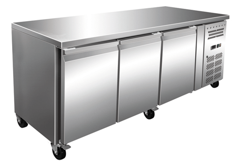 Stainless steel counter freezer with three drawers and wheels for easy mobility, perfect for commercial kitchens.