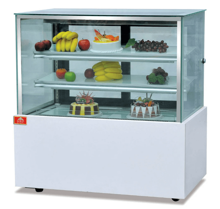 Refrigerated cake counter with transparent glass, displaying fresh fruits and cakes, perfect for cafes and bakeries.