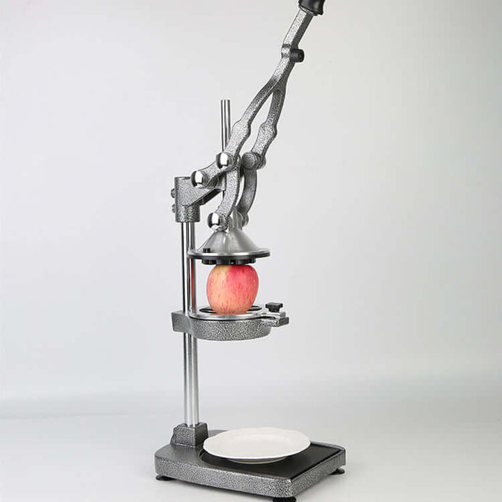 KRD Manual Fruit Juicer Extractor HR1258 with apple, showcasing heavy-duty cast iron design for efficient juice extraction.