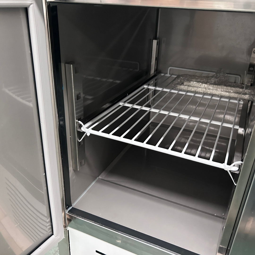 Interior view of a stainless steel Commercial 3 Door Prep Counter Fridge Saladette Table 4xGN1/1 Pans with adjustable shelves.