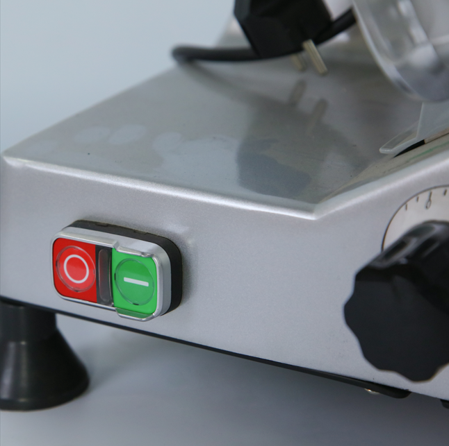 Control panel of KRD B200B4 meat slicer showing power toggle switches in red and green, made of anodized aluminum.