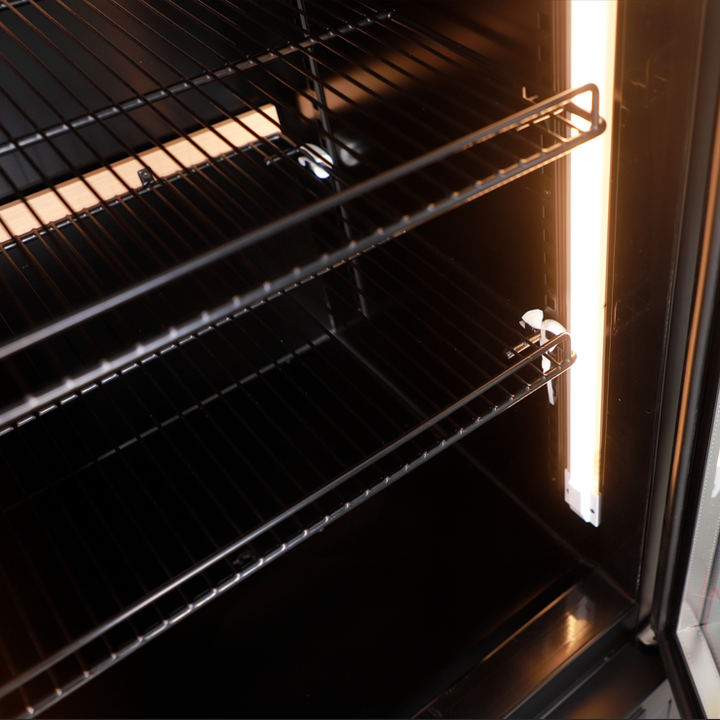 Interior view of KRD Upright Single Door Glass Display Refrigerator Black 61cm LGX426WL showcasing shelves and lighting.